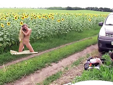 Alena posing between sunflowers